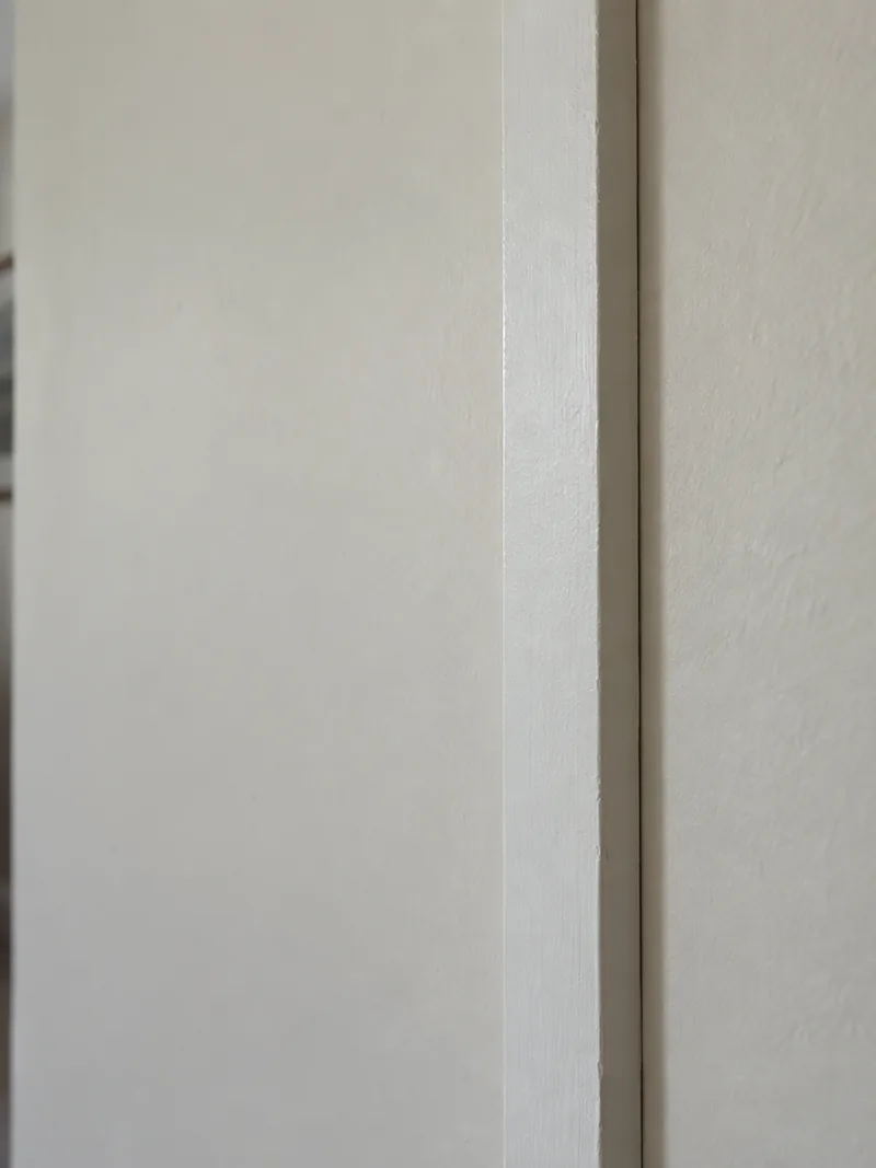 A painted batten strip run down a wall as an architectural detail over a panel joint