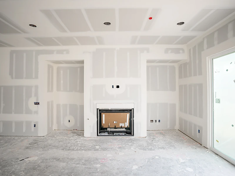 Freshly drywalled living room in a Spring, TX home, taped and ready for texture and paint