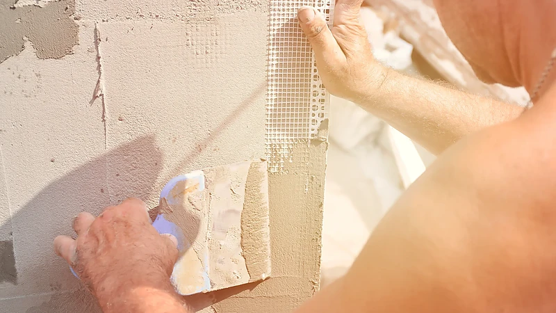 Reinforcing mesh embedded into a plaster coat on an older wall